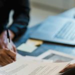 A person filling out paperwork.